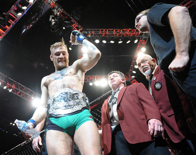 December 12, 2015; Las Vegas, NV, USA; Conor McGregor exits the octagon following his championship victory against Jose Aldo during UFC 194 at MGM Grand Garden Arena. Mandatory Credit: Gary A. Vasquez-USA TODAY Sports