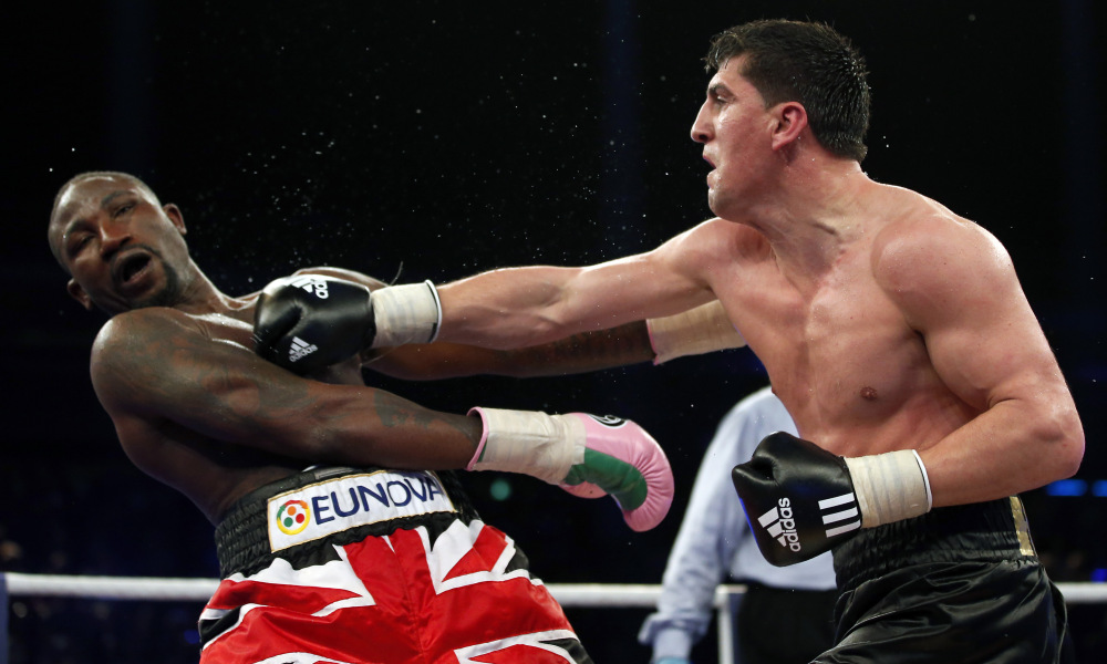 Marco Huck from Germany, right, lands a punch to Britain's Ola Afolabi during their WBO cruiserweight championship title bout in Berlin, Germany, Saturday, June 8, 2013. Huck retained his WBO belt by defeating Afolabi by majority decision on Saturday. (AP Photo/Michael Sohn) ORG XMIT: SOB101