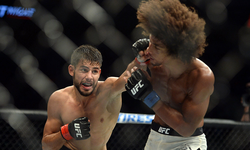 Aug 6, 2016; Salt Lake City, UT, USA; Yair Rodriguez (red gloves) and Alex Caceres (blue gloves) fight during UFC Fight Night at Vivint Smart Home Arena. Rodriguez won via split decision. Mandatory Credit: Joe Camporeale-USA TODAY Sports